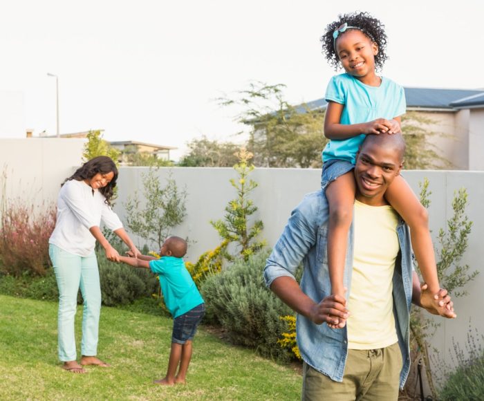 Family having fun in the garden of the house
